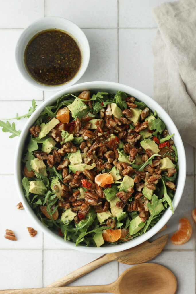 The salad is ready to go in a large white bowl.