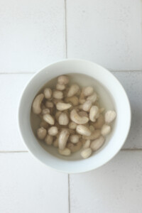 The cashews are soaking in water to soften.