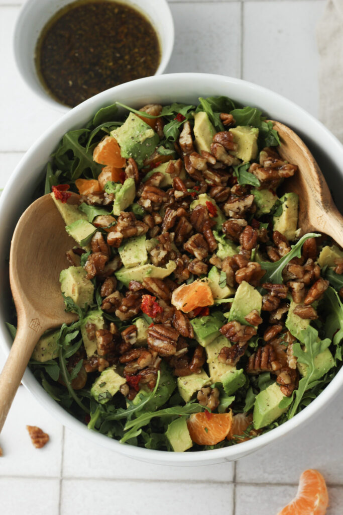 The salad is in a large bowl and is ready to be tossed in dressing.