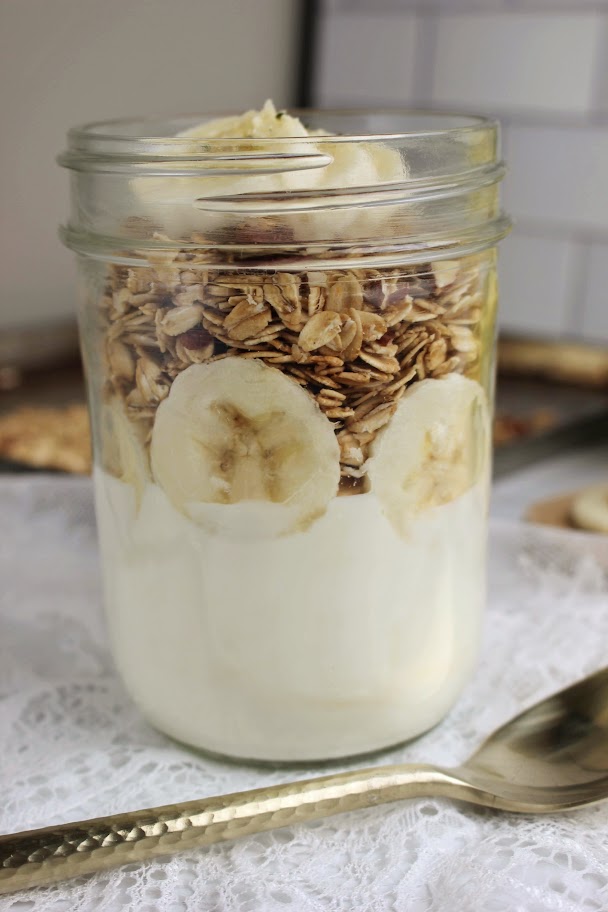 A maple nut granola yogurt jar is finished and ready to eat.