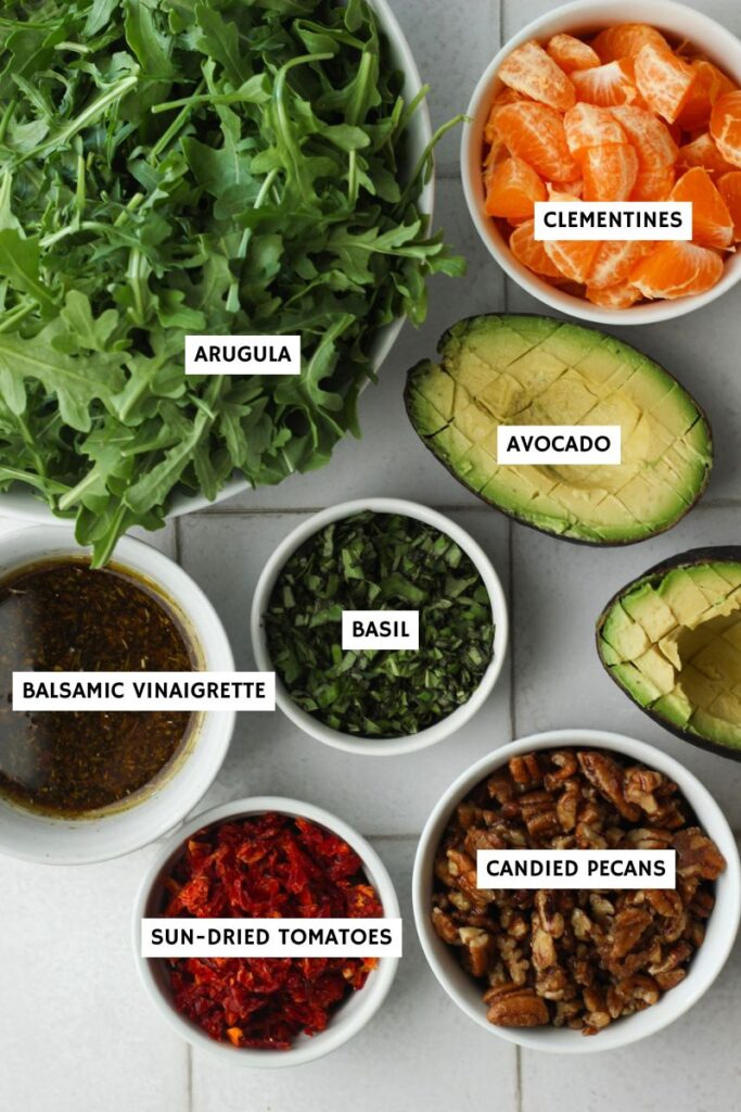 All of the ingredients needed to make this arugula orange salad.