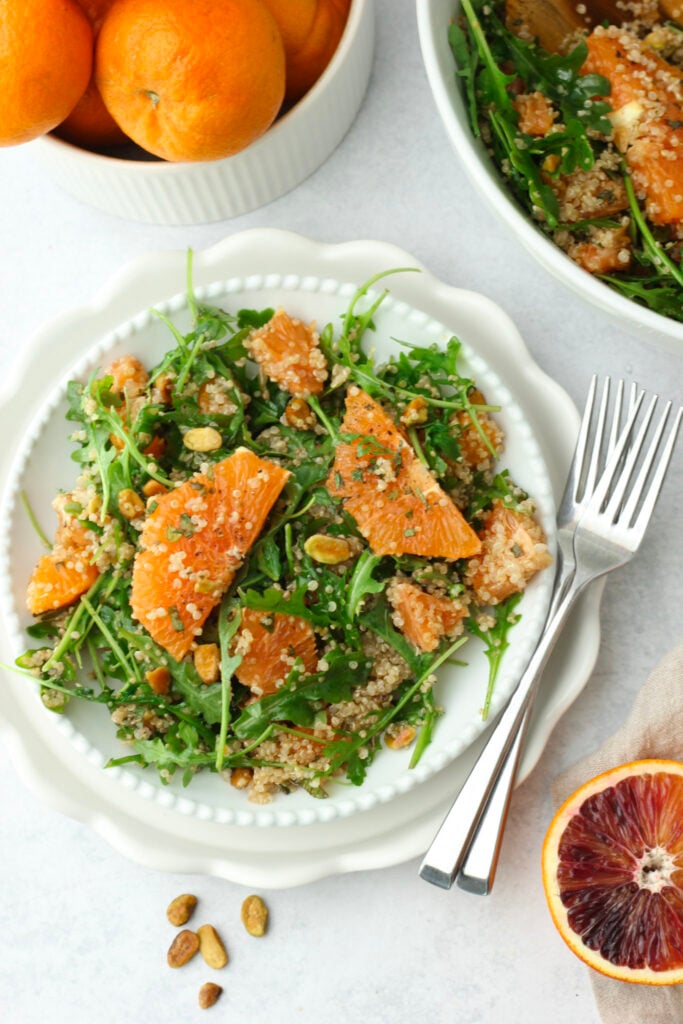 The arugula salad has been served on a single plate.