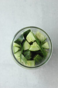 The pickles spears have been added to the mason jar.