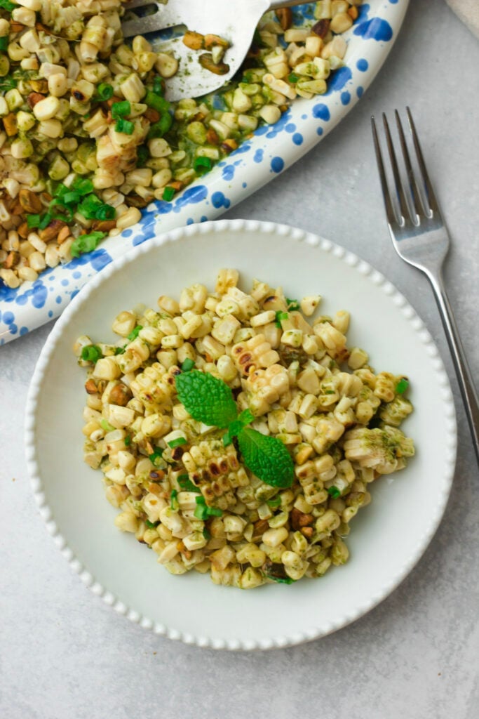 A serving of this grilled corn salad on a small white plate.