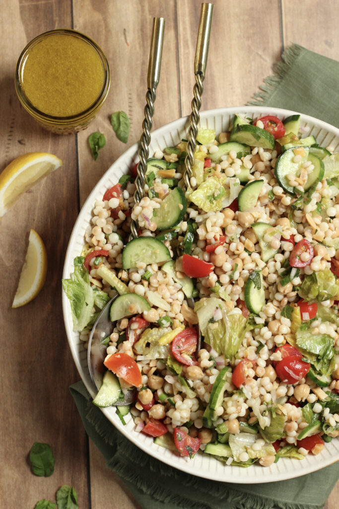 Israeli couscous salad with colorful fresh vegetables.