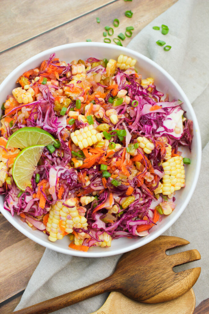 Red cabbage and sweet corn slaw in a serving bowl.