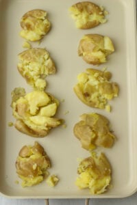 The potatoes have been smashed with the bottom of a glass cup.