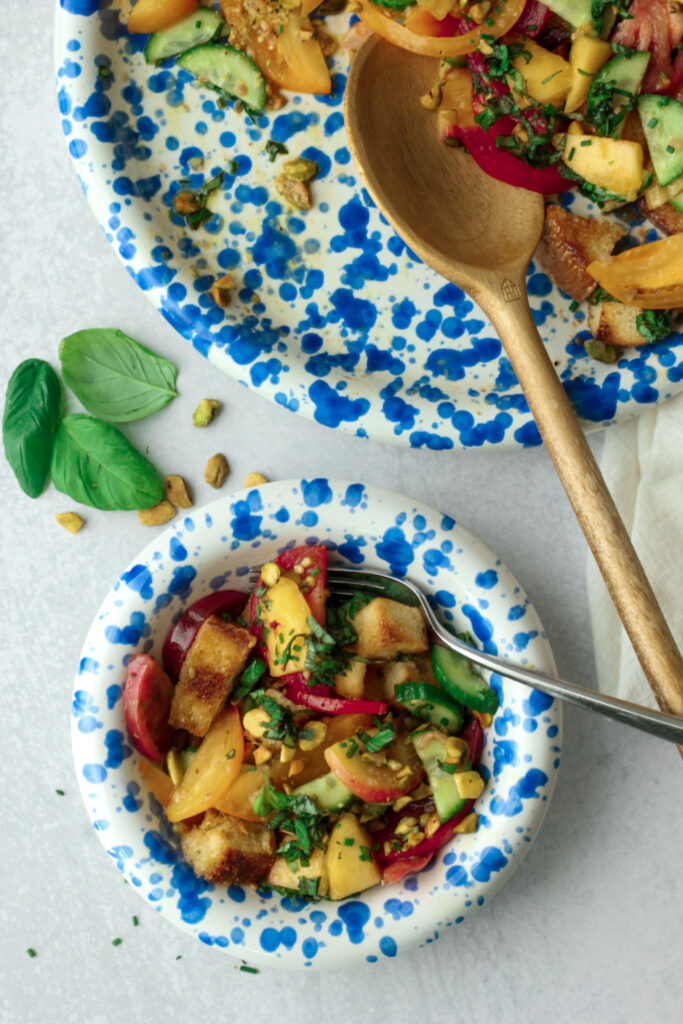 The panzanella salad has been served in an individual bowl.