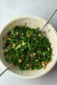 The dressing has been poured and tossed into the salad.