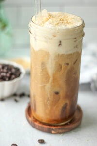 The coconut cream has been poured on top, and the iced coffee is ready to enjoy.