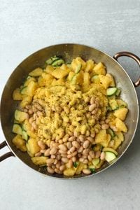 The beans, nutritional yeast, and Italian seasoning have been added to the pan.