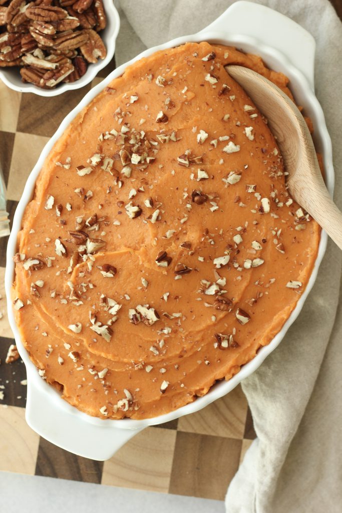 The easy sweet mashed potatoes have been topped with chopped pecans.