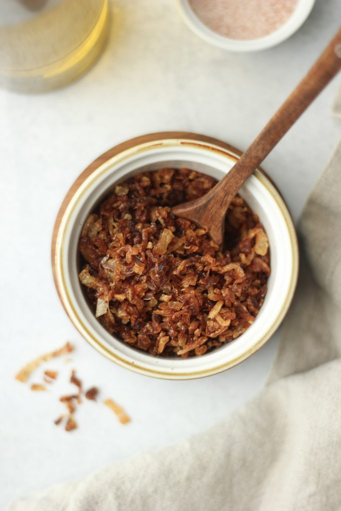 A ramekin filled with crispy shallots.