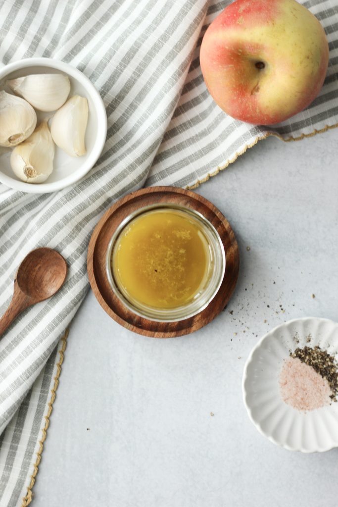 A mason jar filled with homemade apple cider vinaigrette.