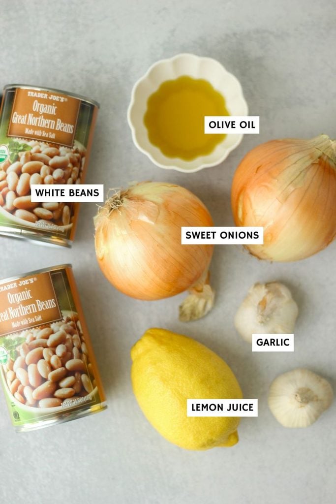 All of the ingredients needed to make this caramelized onion and roasted garlic white bean dip.